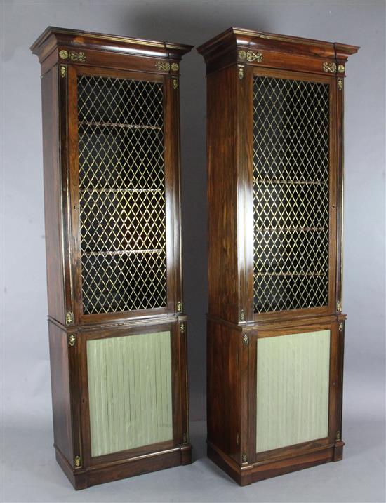 A suite of five Regency rosewood and brass mounted library bookcase cabinets, overall W.25ft 4in. approx.